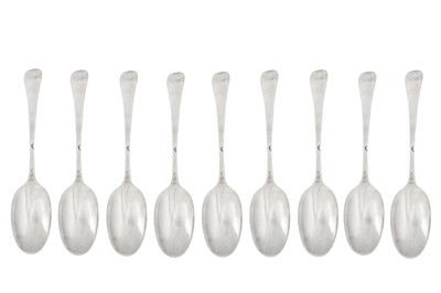 Lot 351 - Nine Queen Anne Britannia standard silver dessert spoons, London 1712 by Lewis Mettayer
