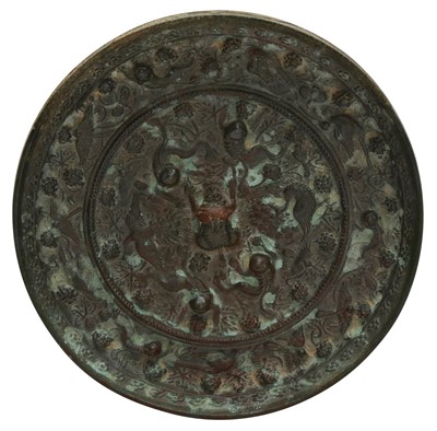 Lot 146 - A CHINESE BRONZE 'LION AND GRAPE' MIRROR