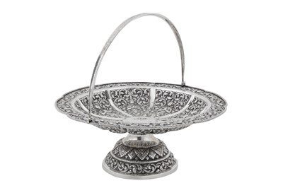Lot 217 - A mid-20th century Cambodian unmarked silver swing handled basket, circa 1960
