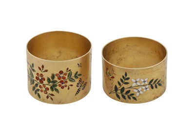 Lot 84 - Two similar Victorian sterling silver gilt and enamel napkin rings, Birmingham 1880, maker’s mark defaced