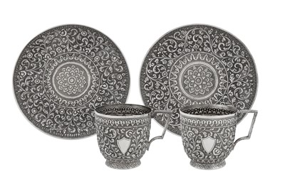 Lot 155 - A pair of late 19th / early 20th century Anglo – Indian silver cups and saucers, Cutch circa 1900 by VK (unidentified)