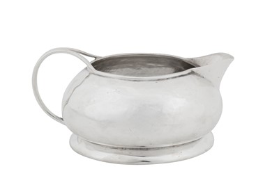 Lot 360 - An Edwardian arts and crafts sterling silver milk jug, Birmingham 1902 by Liberty and Co