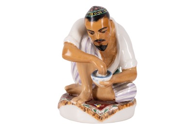 Lot 157 - Soviet Porcelain Figure of an Uzbek Man Eating Pilaf, (attributed) Lomonosov Factory