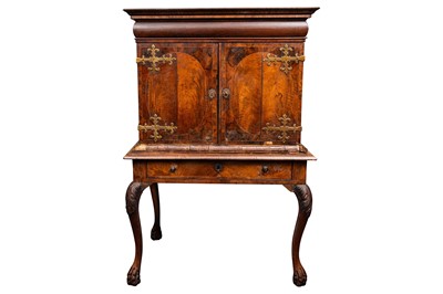 Lot 47 - An early 18th-century Queen Anne figured walnut cabinet on a stand