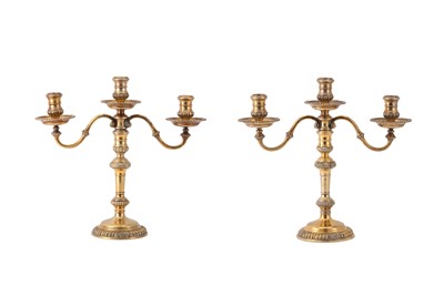 Lot 381 - A pair of Elizabeth II sterling silver gilt three-light candelabra, London 1975 by Asprey and Co