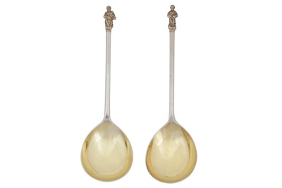 Lot 331 - A pair of Victorian sterling silver gilt apostle fruit serving spoons, London 1877 by Henry Holland