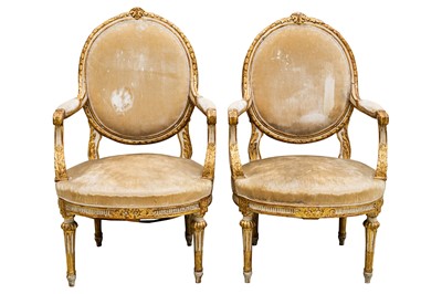 Lot 6 - A pair of Louis XVI French parcel gilt and white painted fauteuils