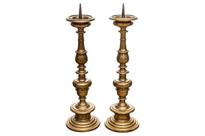 Lot 100 - A pair of Bologna, Italy brass pricket candlesticks, 17th century