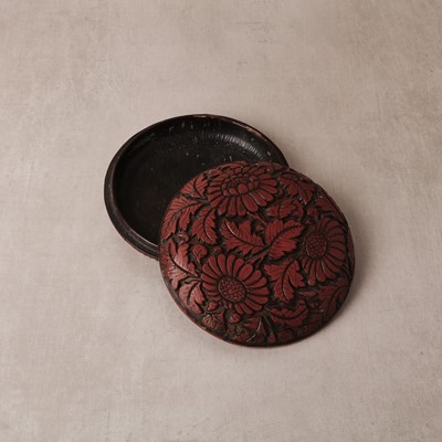 Lot 71 - A rare Chinese cinnabar lacquer 'chrysanthemum' box and cover, Ming dynasty