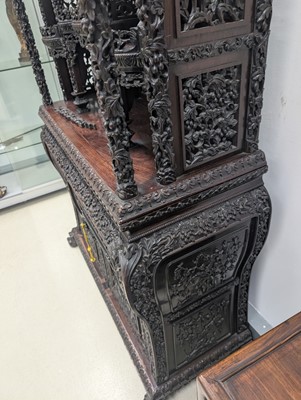 Lot 130 - A fine Chinese export carved and pierced hardwood (hongmu) display cabinet, late 19th century