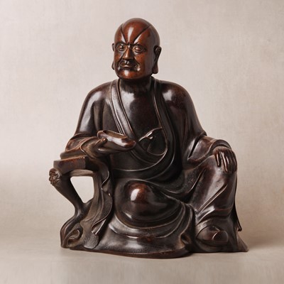 Lot 75 - A Chinese silver-inlaid bronze figure of a Luohan, late Qing dynasty