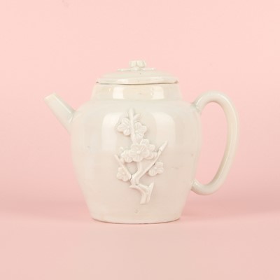 Lot 23 - A Chinese Dehua 'prunus' teapot and cover, Transitional - Qing dynasty, Shunzhi - Kangxi period