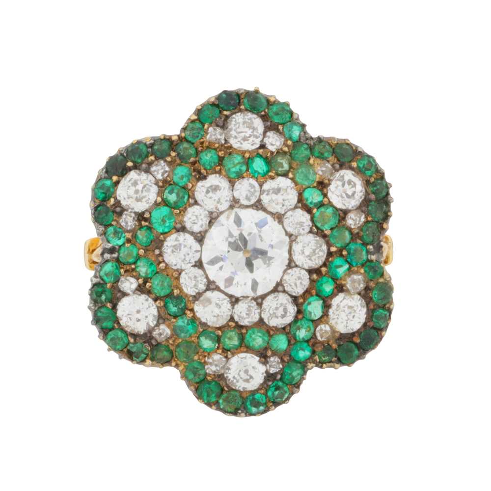 244 - An emerald and diamond flower ring