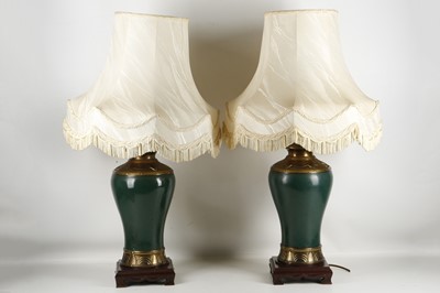 Lot 523 - A pair of table lamps, brass leaf collar over...