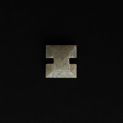 Lot 514 - A Chinese jade archaistic bead, 19th century or earlier
