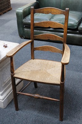 Lot 836 - An early 20th century ladderback elbow chair,...