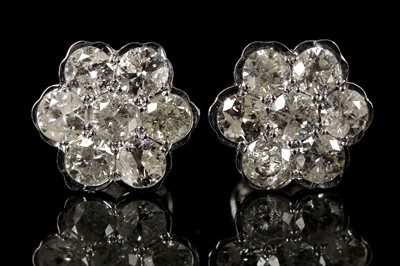 Lot 498 - A pair of 18ct white gold, screw-back 7 stone...