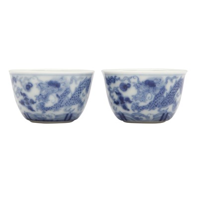 Lot 68 - Two Chinese blue and white 'dragon' cups, Qing dynasty, Guangxu period