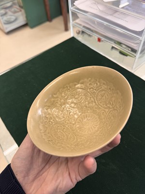 Lot 463 - A Chinese Yaozhou celadon 'lotus scroll' conical bowl, Song dynasty