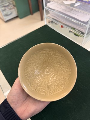 Lot 463 - A Chinese Yaozhou celadon 'lotus scroll' conical bowl, Song dynasty