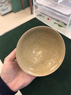 Lot 463 - A Chinese Yaozhou celadon 'lotus scroll' conical bowl, Song dynasty