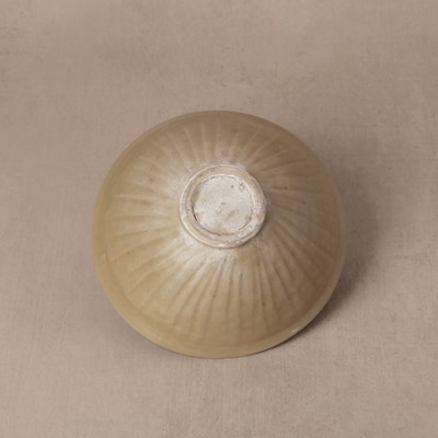 Lot 463 - A Chinese Yaozhou celadon 'lotus scroll' conical bowl, Song dynasty