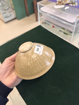 Lot 463 - A Chinese Yaozhou celadon 'lotus scroll' conical bowl, Song dynasty