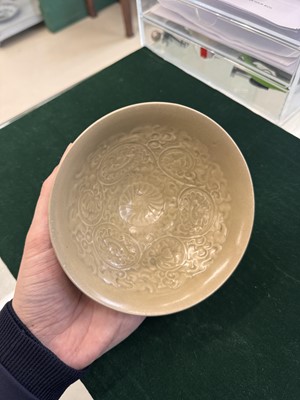 Lot 463 - A Chinese Yaozhou celadon 'lotus scroll' conical bowl, Song dynasty