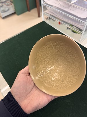 Lot 463 - A Chinese Yaozhou celadon 'lotus scroll' conical bowl, Song dynasty