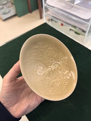 Lot 463 - A Chinese Yaozhou celadon 'lotus scroll' conical bowl, Song dynasty