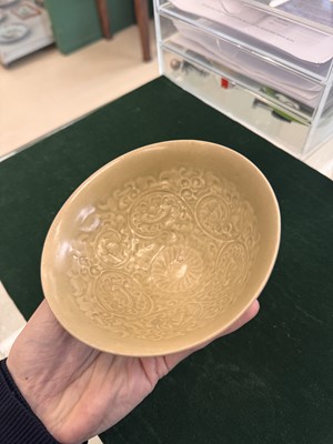 Lot 463 - A Chinese Yaozhou celadon 'lotus scroll' conical bowl, Song dynasty