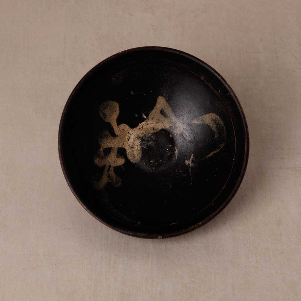 Lot 457 - A Chinese Jizhou glazed-glaze 'floral' painted bowl, Southern Song dynasty