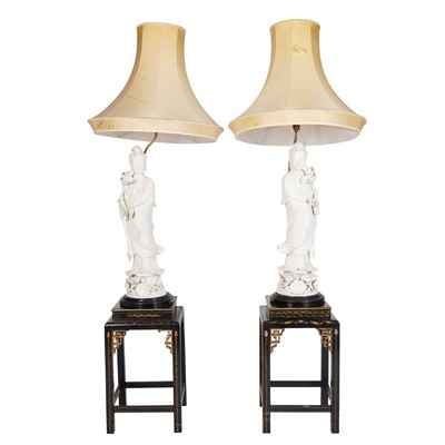 Lot 102 - A pair of Chinese blanc-de-Chine figural lamps and a pair of Chinese hardwood lamp stands