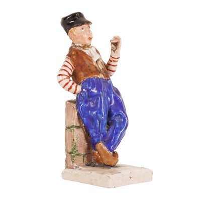 Lot 299 - A small continental pottery figure of a sailor boy