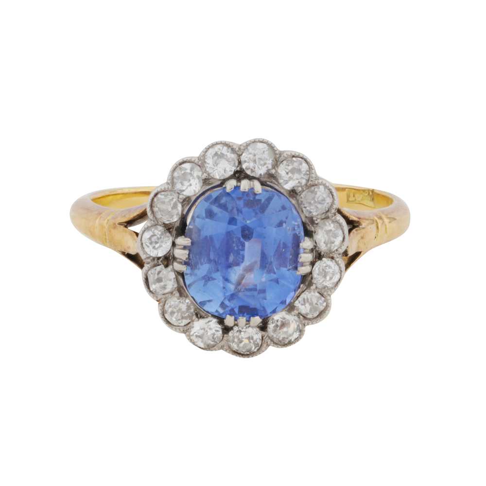 Lot 25 - A sapphire and diamond halo ring