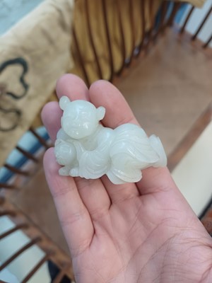 Lot 106 - A Chinese jade 'boy and cat' carving, Qing dynasty, 19th century