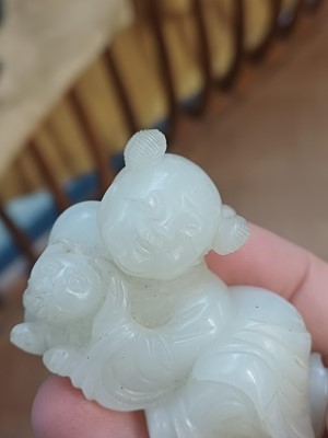 Lot 106 - A Chinese jade 'boy and cat' carving, Qing dynasty, 19th century