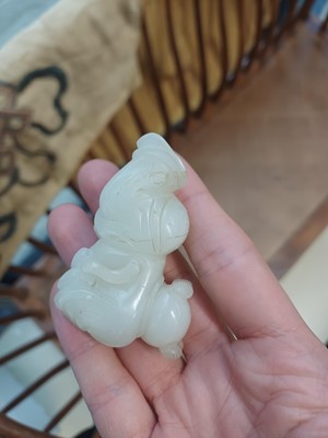 Lot 106 - A Chinese jade 'boy and cat' carving, Qing dynasty, 19th century