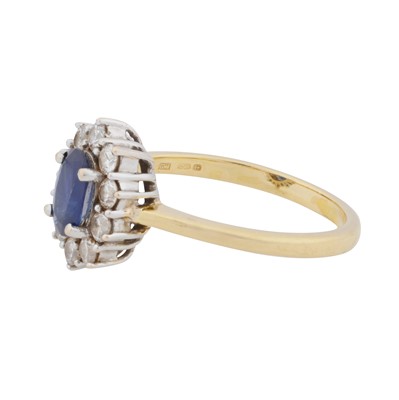 Lot 38 - A sapphire and diamond halo ring