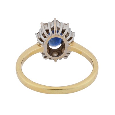 Lot 38 - A sapphire and diamond halo ring