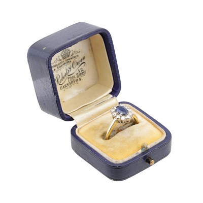 Lot 38 - A sapphire and diamond halo ring