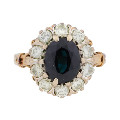 Lot 30 - A sapphire and diamond halo ring