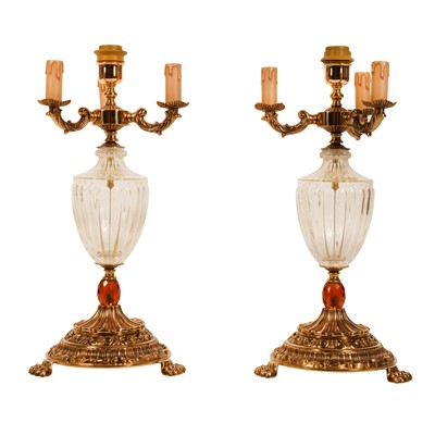Lot 103 - A pair of gilt metal and glass three light candelabra lamps