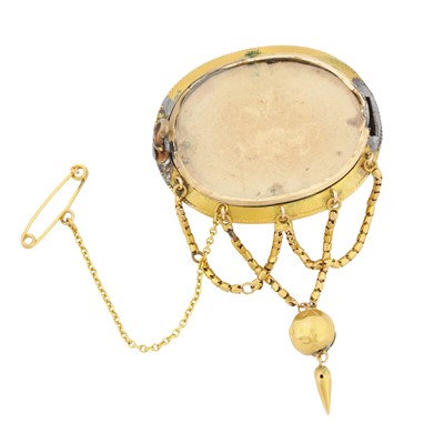 Lot 6 - A rock crystal ornate oval brooch