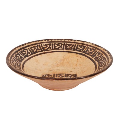 Lot 263 - A Persian Slip-Painted Pottery Bowl with Kufic Inscription