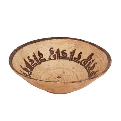 Lot 260 - A Persian Slip-Painted Pottery Bowl with Kufic Inscription