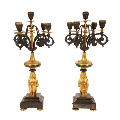 Lot 170 - A pair of Empire Egyptian revival style patinated and gilt bronze five light candelabra
