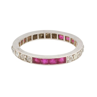 Lot 58 - A ruby and diamond full eternity ring