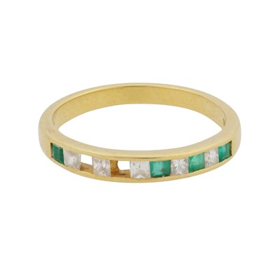 Lot 169 - An emerald and diamond half eternity ring