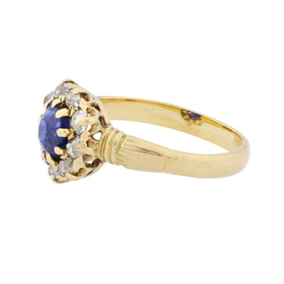 Lot 37 - A sapphire and diamond halo ring